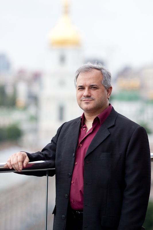 Nonfiction editor, Evan Ostryzniuk standing on the blurred background